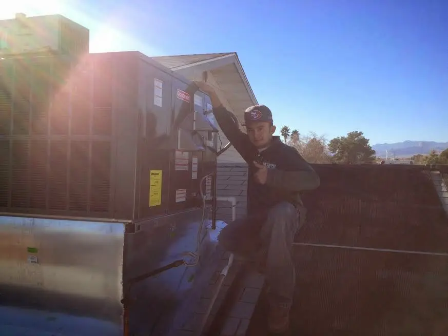 HVAC technician performing Boiler Repair on a rooftop unit in Aliso Viejo
